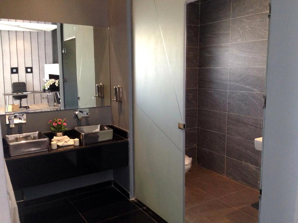 Bathroom countertop neatly arranged with skincare and toiletries