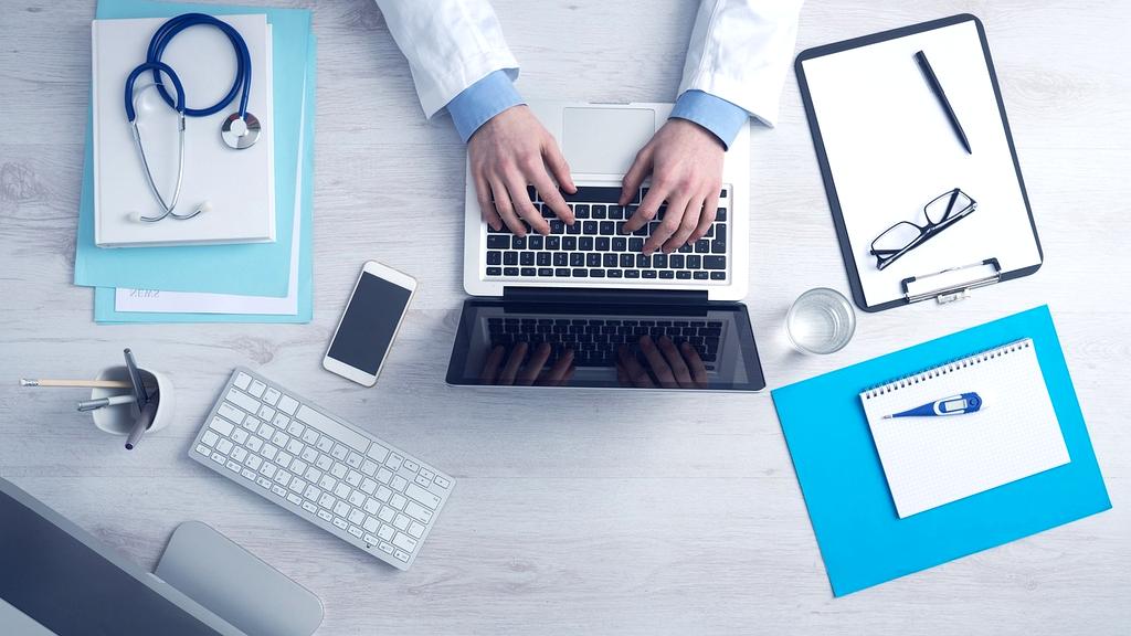 Clean organized home office desk with filing systems and productivity tools